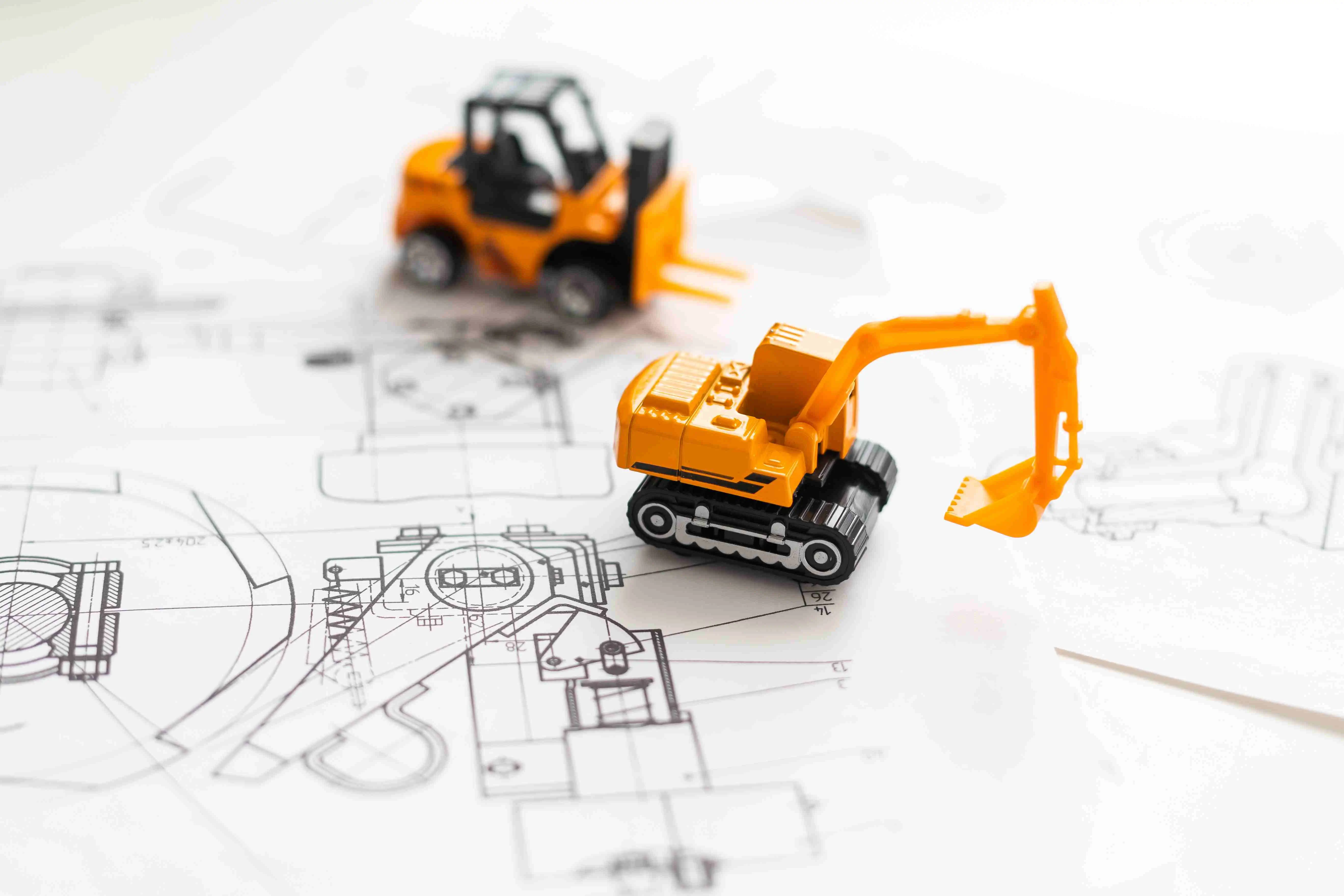 Toy construction vehicles on a blueprint