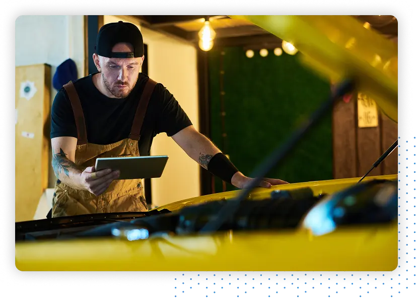 Mechanic inspecting a yellow car
