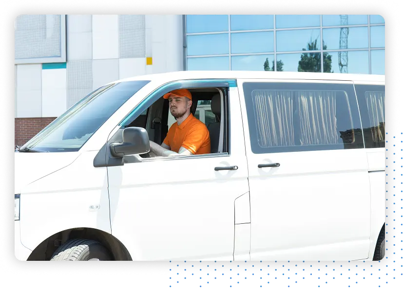 Person wearing an Orange Shirt driving a White Van